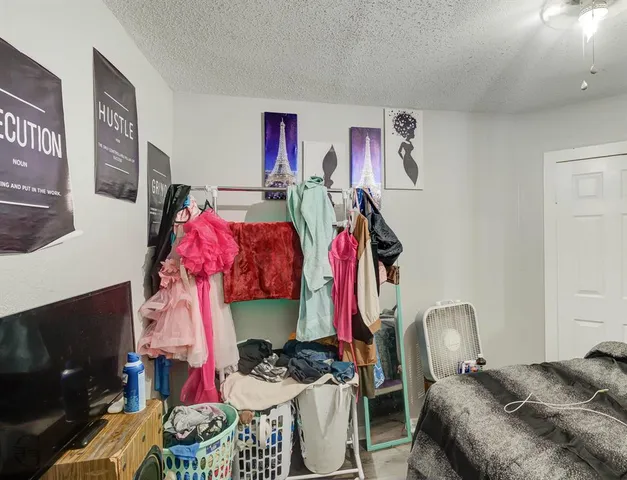 a view of a bedroom with workspace and a couch