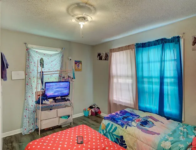 a bedroom with bed and a window