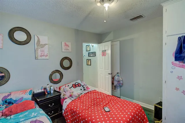 a bedroom with a bed and a chandelier