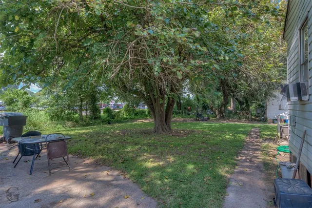a view of a backyard with sitting area