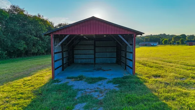a view of a small house with a yard