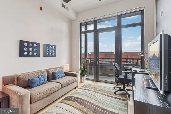 a view of a living room hardwood floor and a ceiling fan