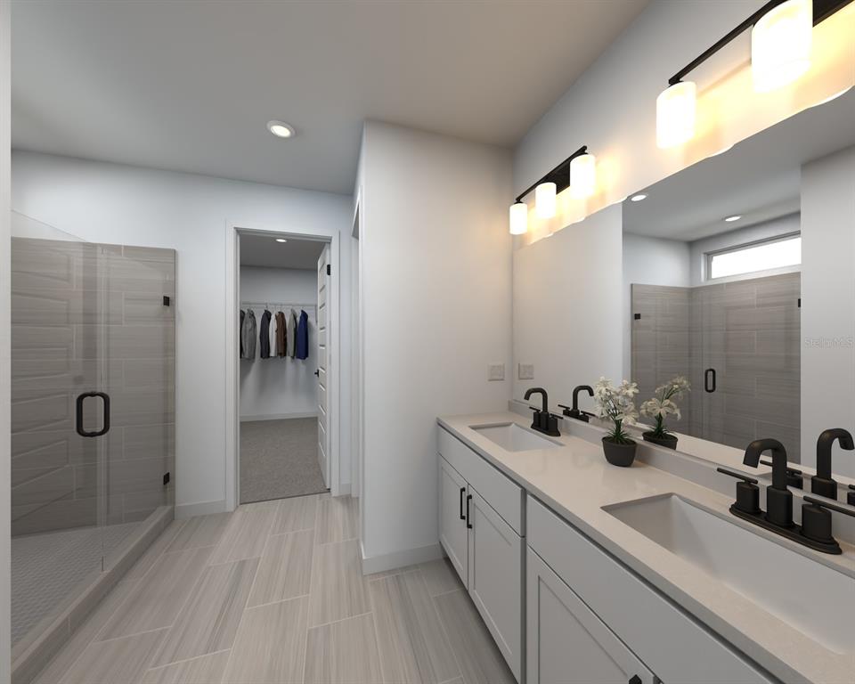 13323 Shellmore Avenue Palmetto, FL 34221 - Photo 8 of 8 a bathroom with a double vanity sink a mirror and shower