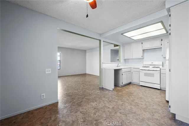 a kitchen with white cabinets and white appliances
