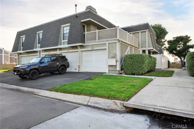 a view of a car parked in front of a house