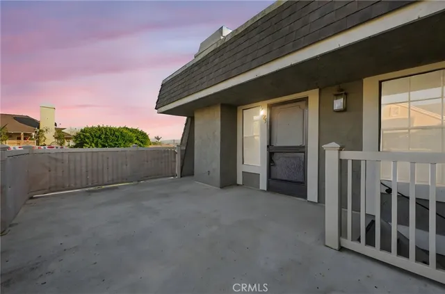 a view of a house with a wooden fence