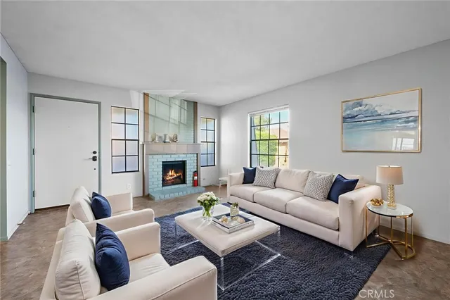 a living room with furniture a fireplace and window