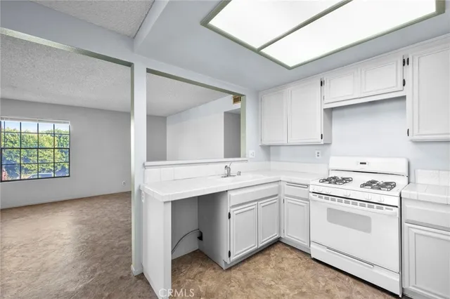 a kitchen with a sink stove and cabinets