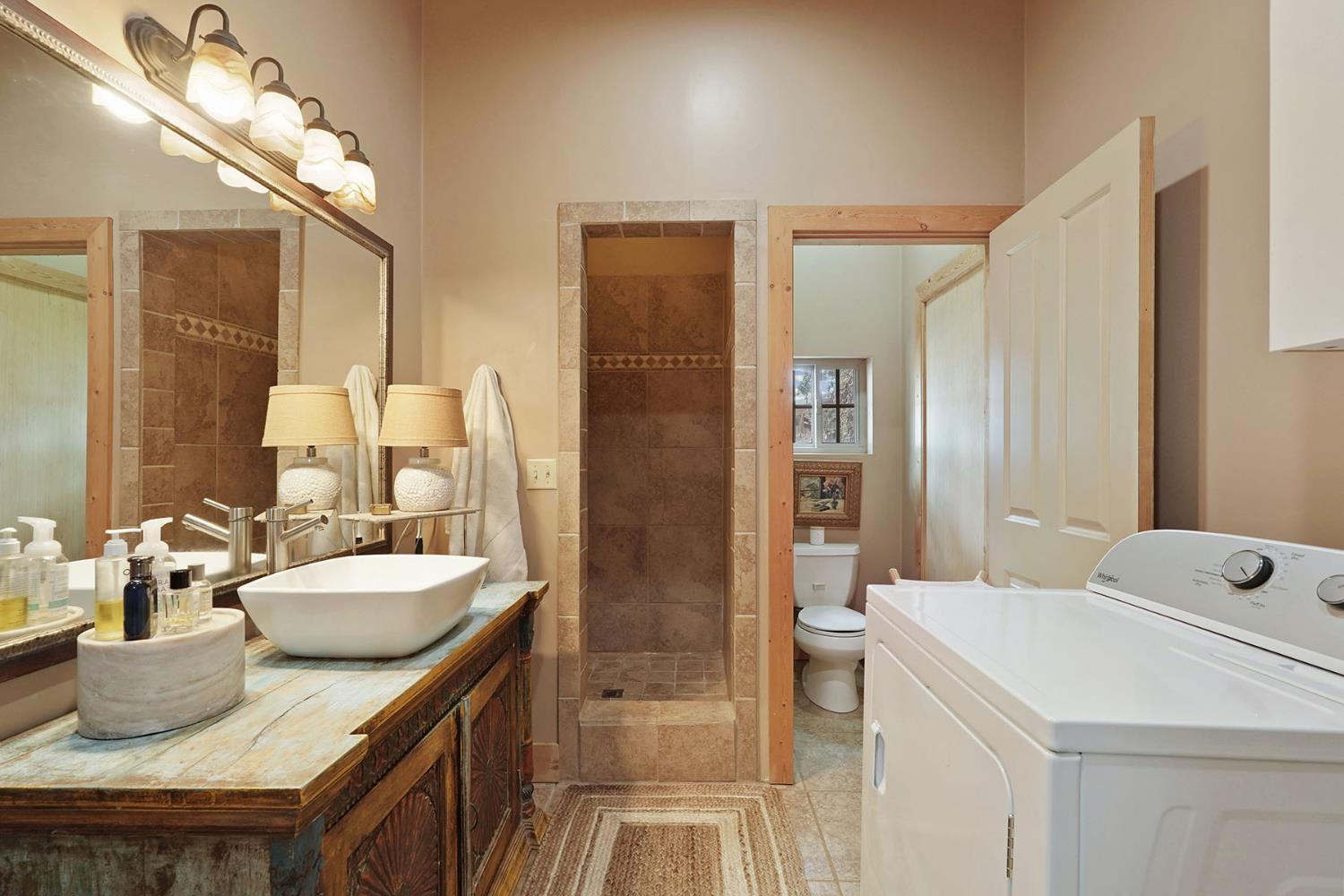 21754 North Cord Road Clements, CA 95227 - Photo 19 of 60 a bathroom with a granite countertop sink a toilet and shower