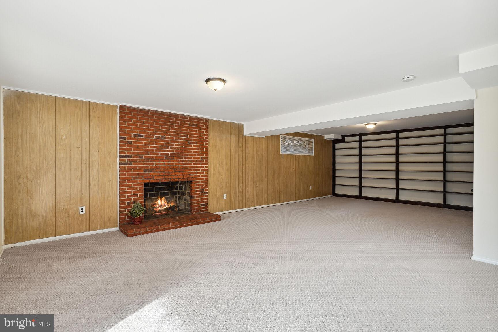 6420 Hollins Drive Bethesda, MD 20817 - Photo 23 of 34 Large brick fireplace and shelving