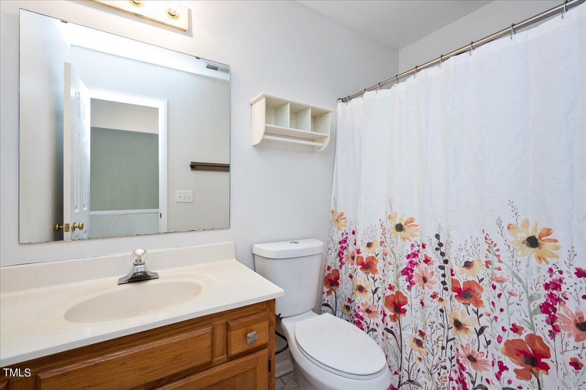 4201 Loon Lane Raleigh, NC 27616 - Photo 17 of 31 a bathroom with a sink toilet and shower