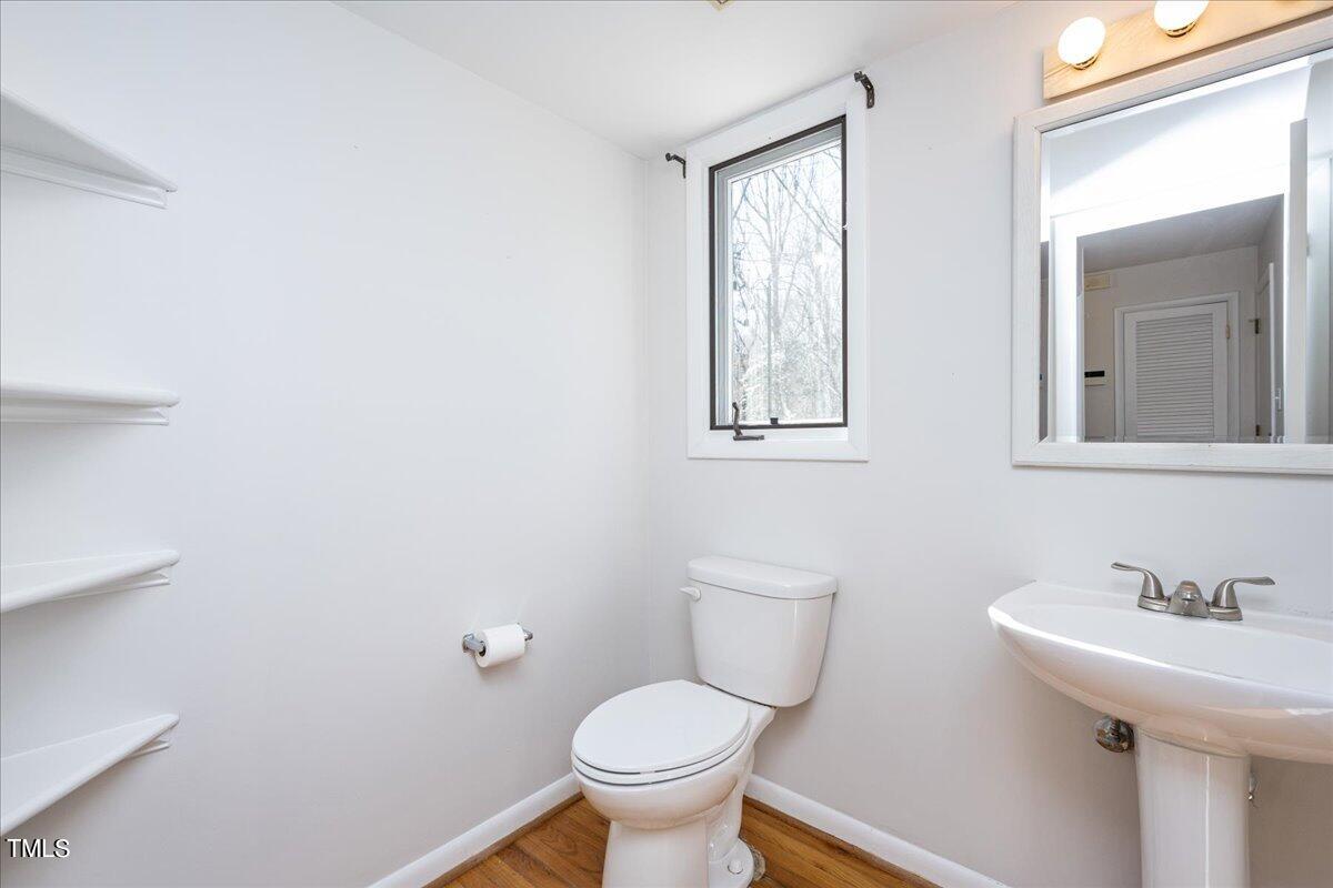 4201 Loon Lane Raleigh, NC 27616 - Photo 20 of 31 a bathroom with a toilet sink and mirror