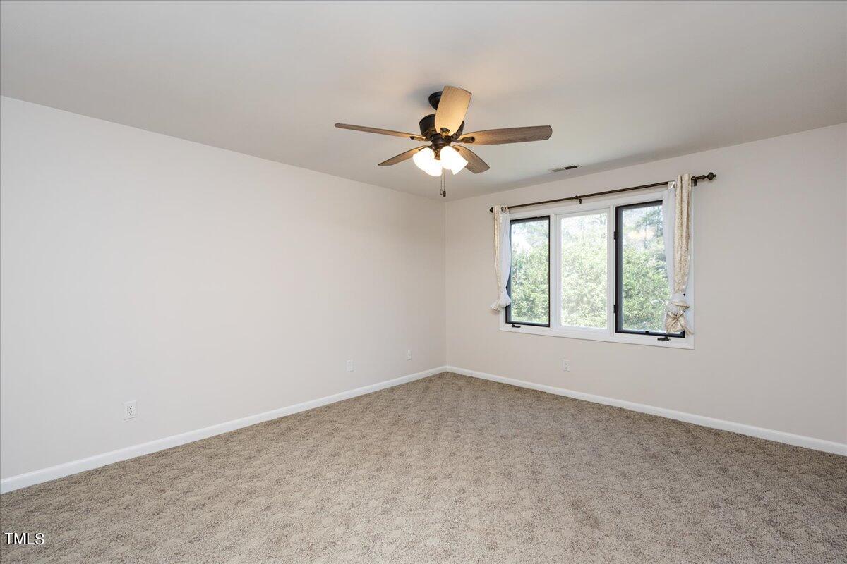 4201 Loon Lane Raleigh, NC 27616 - Photo 22 of 31 an empty room with a window and a fan