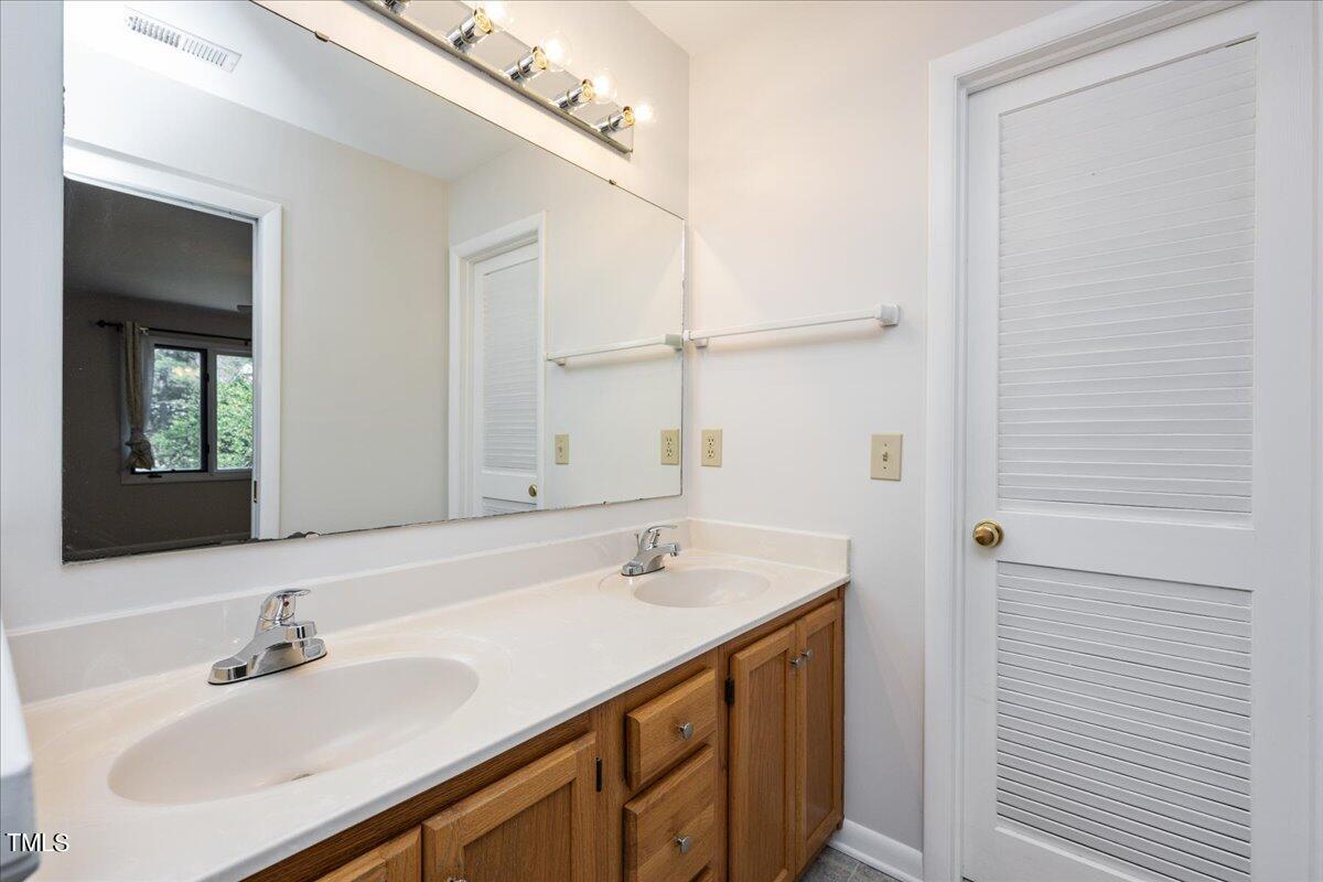 4201 Loon Lane Raleigh, NC 27616 - Photo 23 of 31 a bathroom with a sink and a mirror