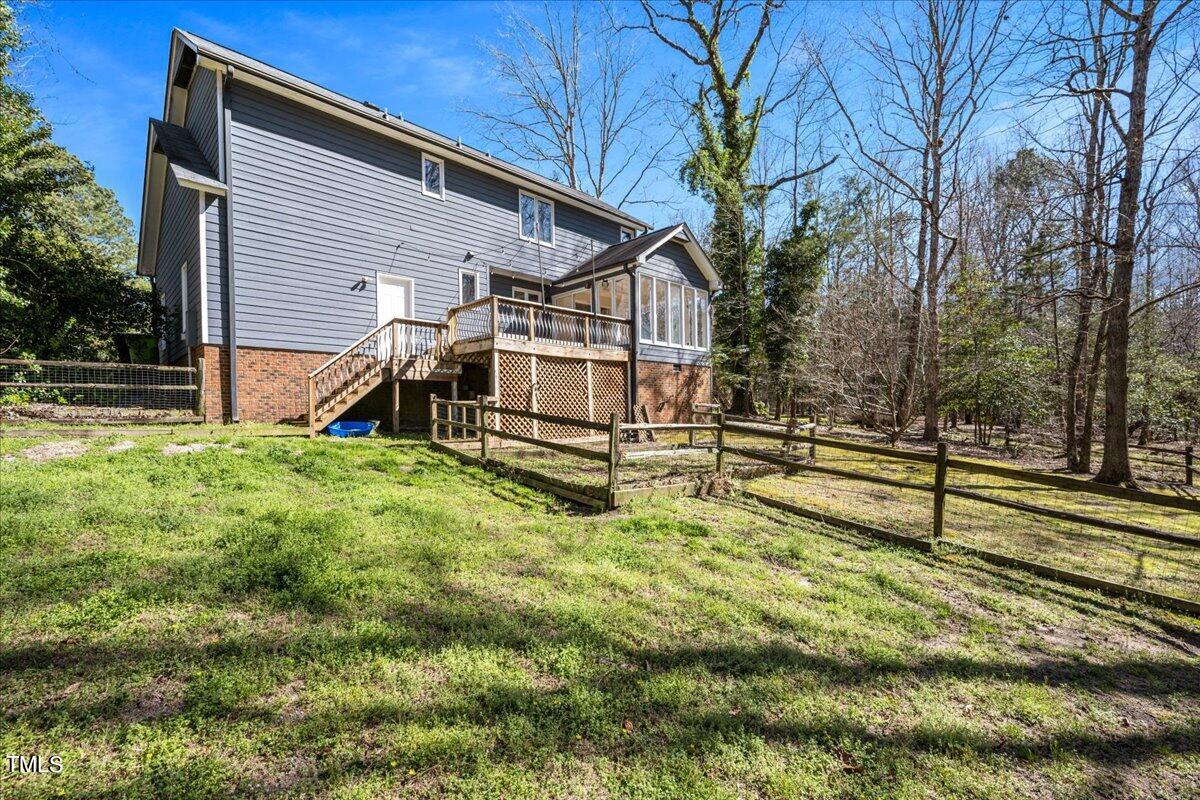 4201 Loon Lane Raleigh, NC 27616 - Photo 27 of 31 a view of backyard with wooden fence and a large tree