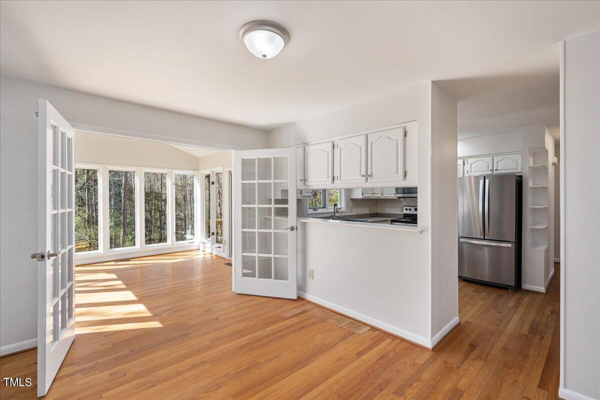 4201 Loon Lane Raleigh, NC 27616 - Photo 8 of 31 a view of a kitchen with wooden floor and electronic appliances