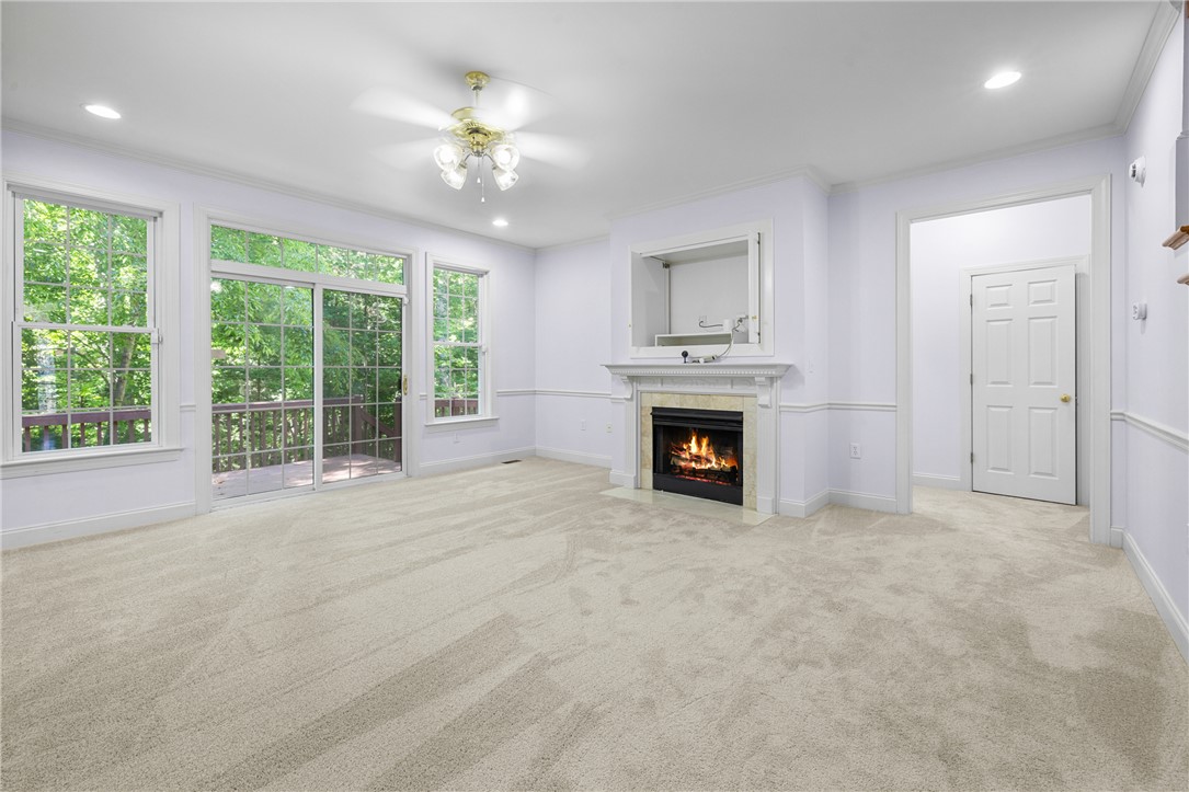110 Brookstone Way Central, SC 29630 - Photo 16 of 46 This bright living space features a cozy fireplace and large windows offering verdant views.