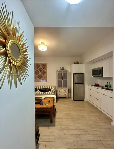 a en suite bathroom with a tub sink and mirror