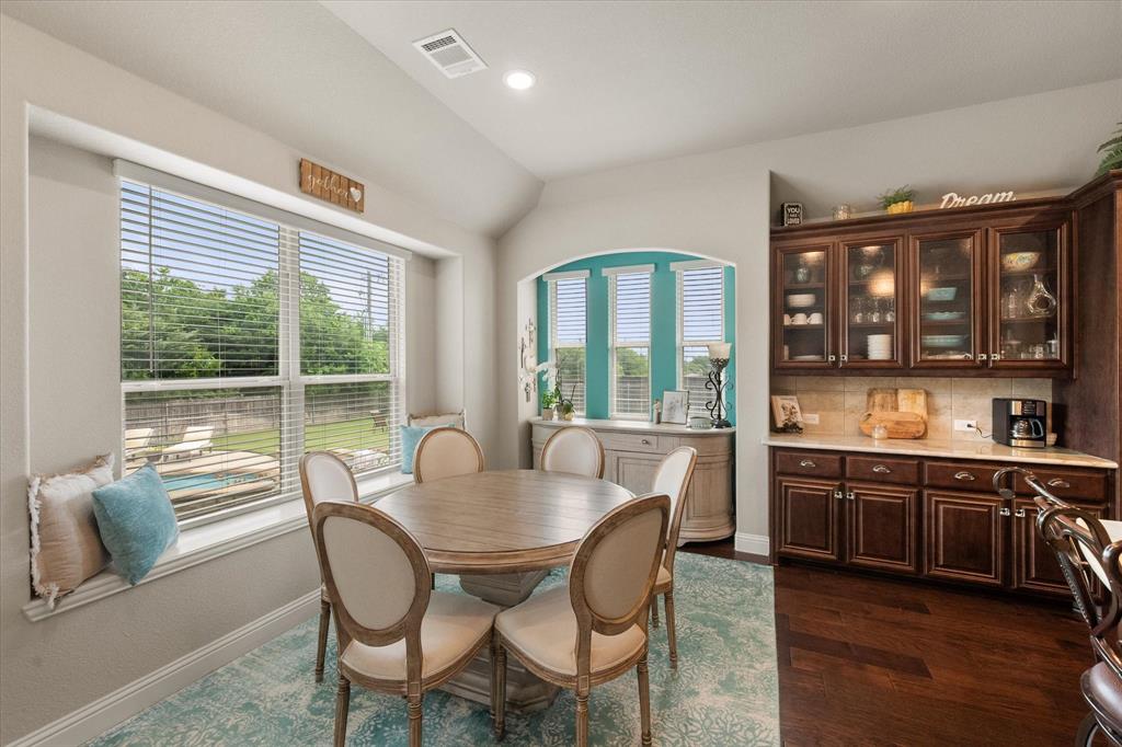 445 Rusty Run Drive Midlothian, TX 76065 - Photo 22 of 40 a view of a dining room with furniture large windows and wooden floor