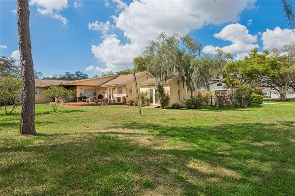 an aerial view of a house with a yard and lake view