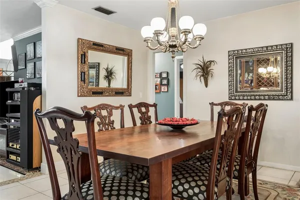 a view of a dining room with furniture and chandelier