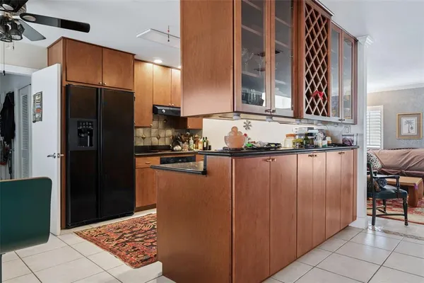 a kitchen with granite countertop a refrigerator and a stove top oven