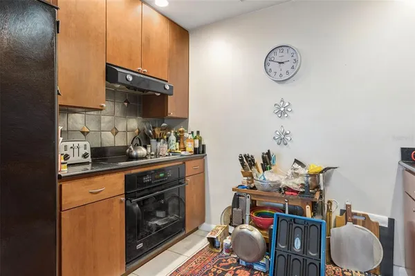 a kitchen with stainless steel appliances granite countertop a sink dishwasher stove and cabinets with wooden floor