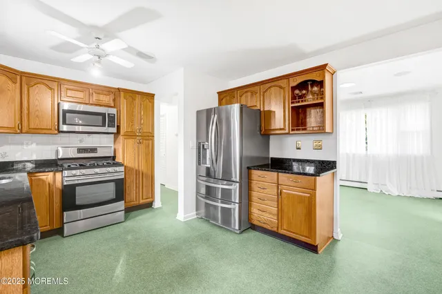 a kitchen with stainless steel appliances granite countertop a stove a refrigerator and a refrigerator