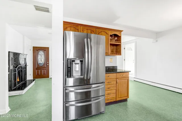 a kitchen with stainless steel appliances granite countertop a refrigerator and a stove