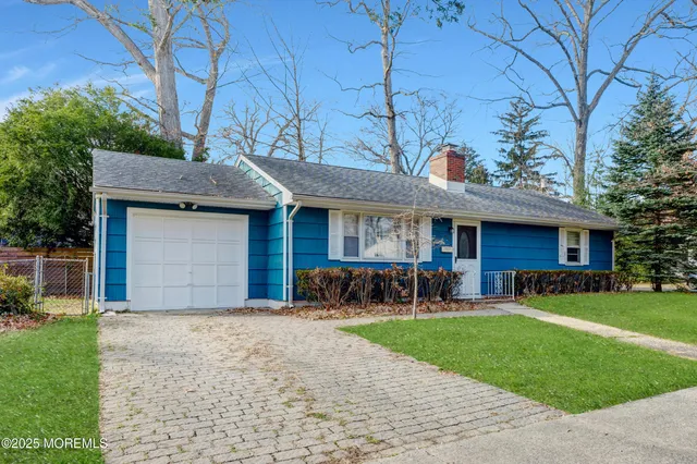 a front view of a house with garden and porch