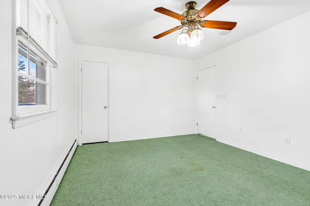 a view of a room with wooden floor and white walls
