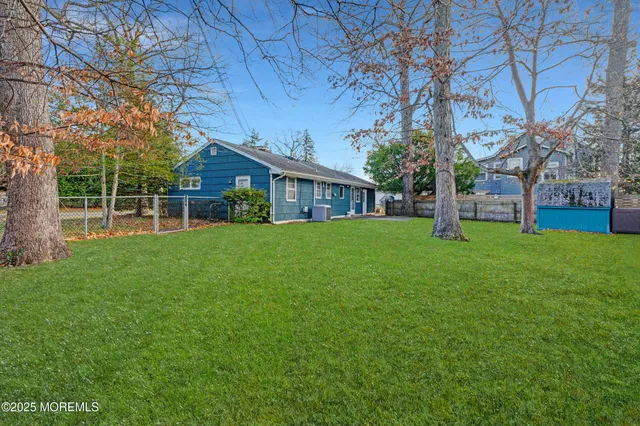 an aerial view of a house with a yard and garden