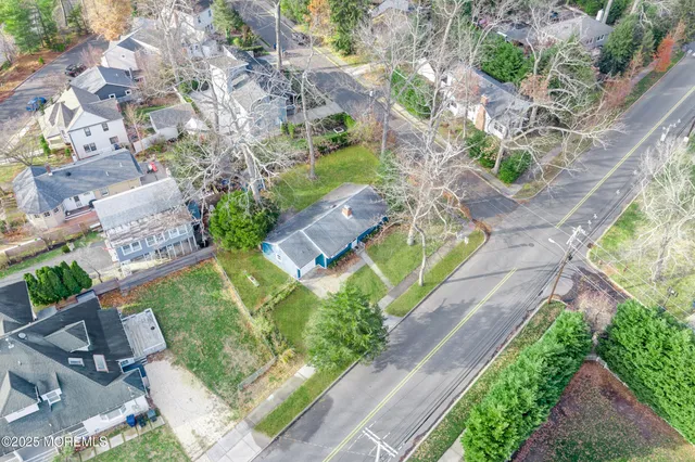 a front view of a house with a yard and potted plants