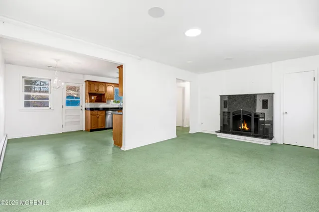 an empty room with furniture and a fireplace