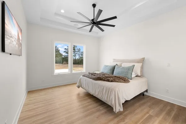 a bed sitting in a bedroom next to a window