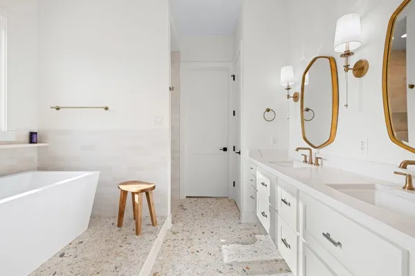 a bathroom with a double vanity sink and a mirror