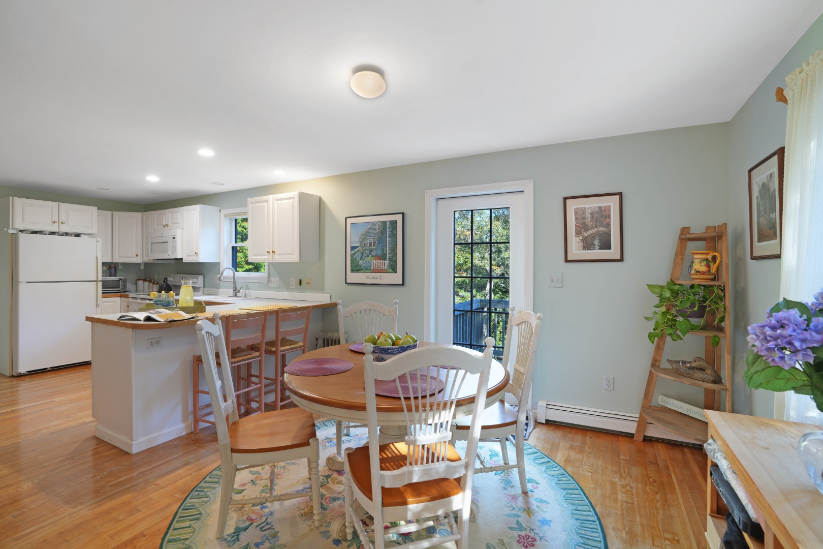 22 Old Lighthouse Road Vineyard Haven, MA 02568 - Photo 3 of 26 a open dining room with wooden floor and kitchen view