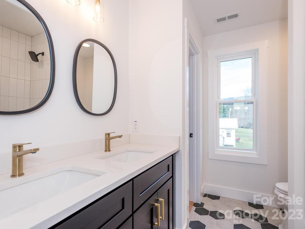 485 Oakdale Road Waynesville, NC 28786 - Photo 11 of 22 a bathroom with a sink and a mirror