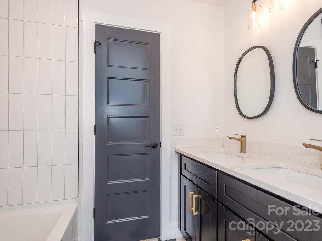 485 Oakdale Road Waynesville, NC 28786 - Photo 12 of 22 a bathroom with a sink and a mirror