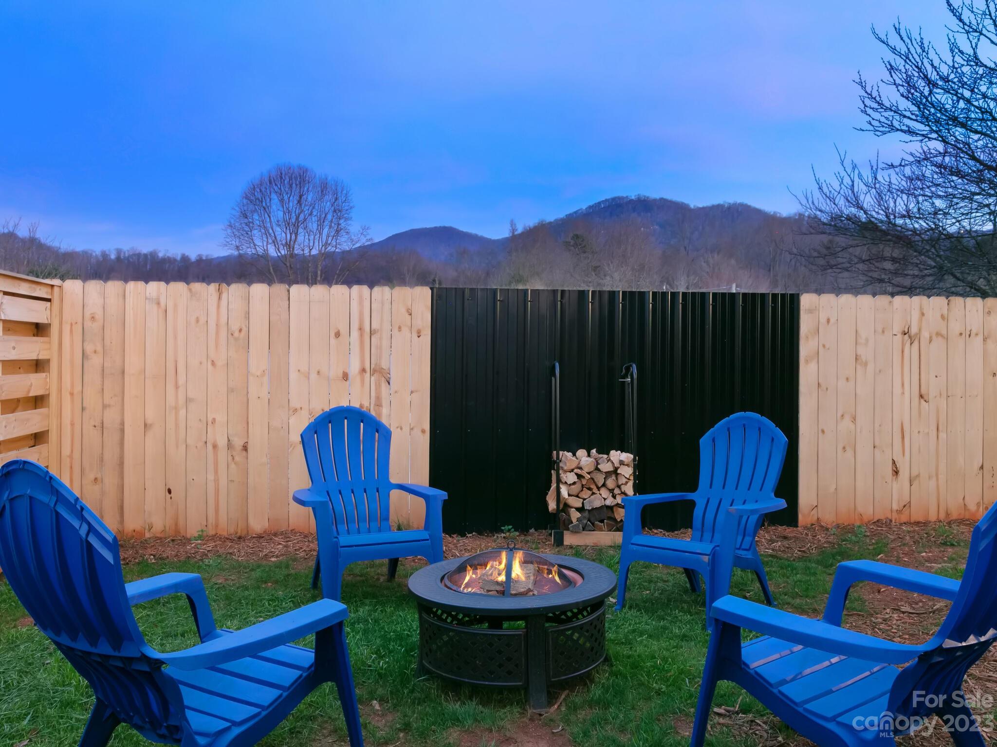 485 Oakdale Road Waynesville, NC 28786 - Photo 18 of 22 a backyard of a house with fire pit and outdoor seating