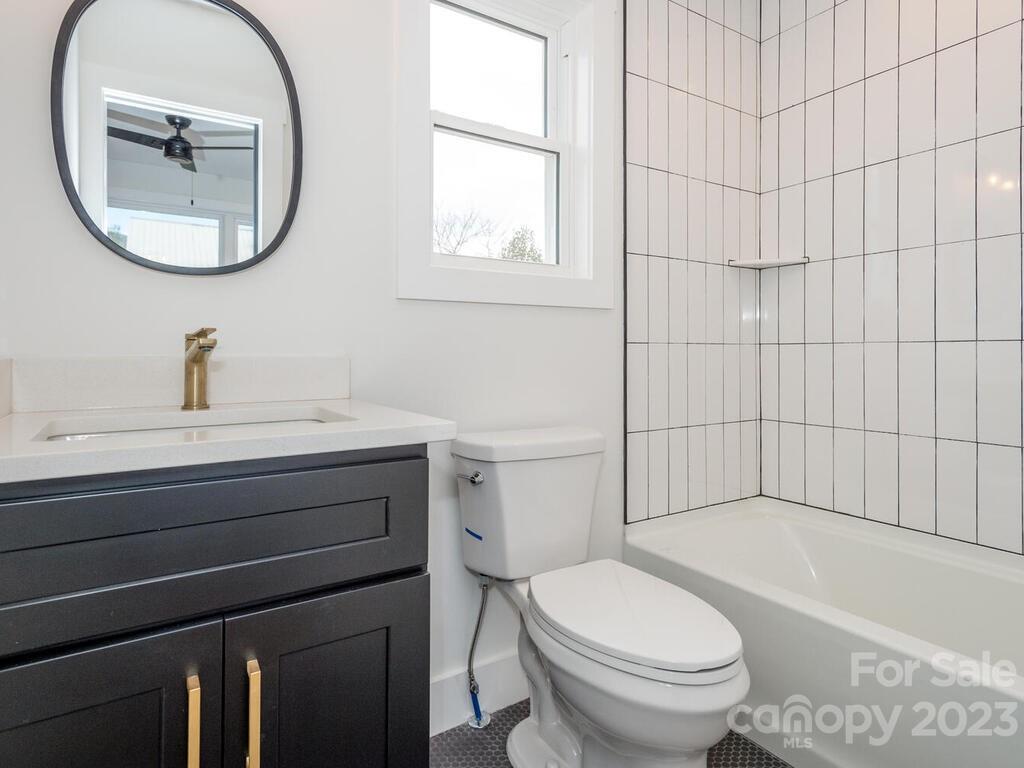 485 Oakdale Road Waynesville, NC 28786 - Photo 8 of 22 a bathroom with a sink a toilet and bathtub