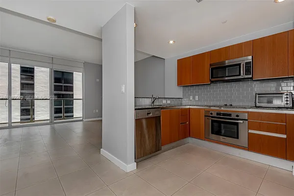 a kitchen with stainless steel appliances granite countertop a stove and a sink