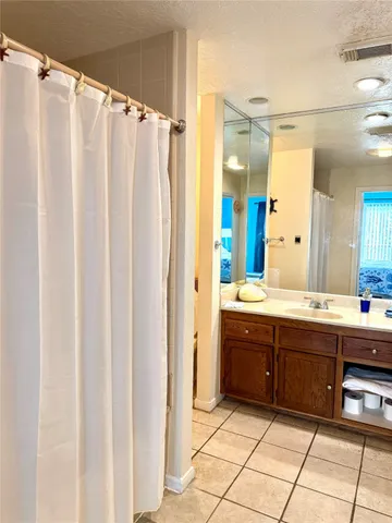 a spacious bathroom with a double vanity sink mirror and shower