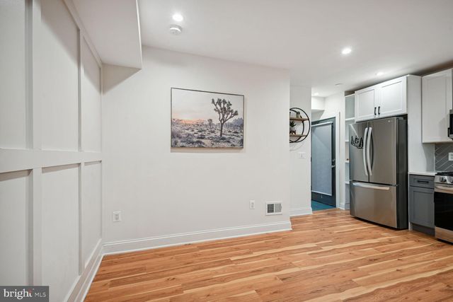 a view of a refrigerator in kitchen and wooden floor