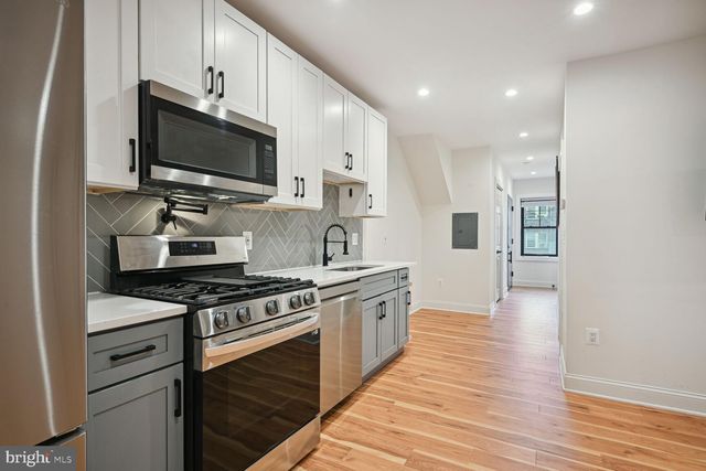 a kitchen with stainless steel appliances a stove microwave and cabinets
