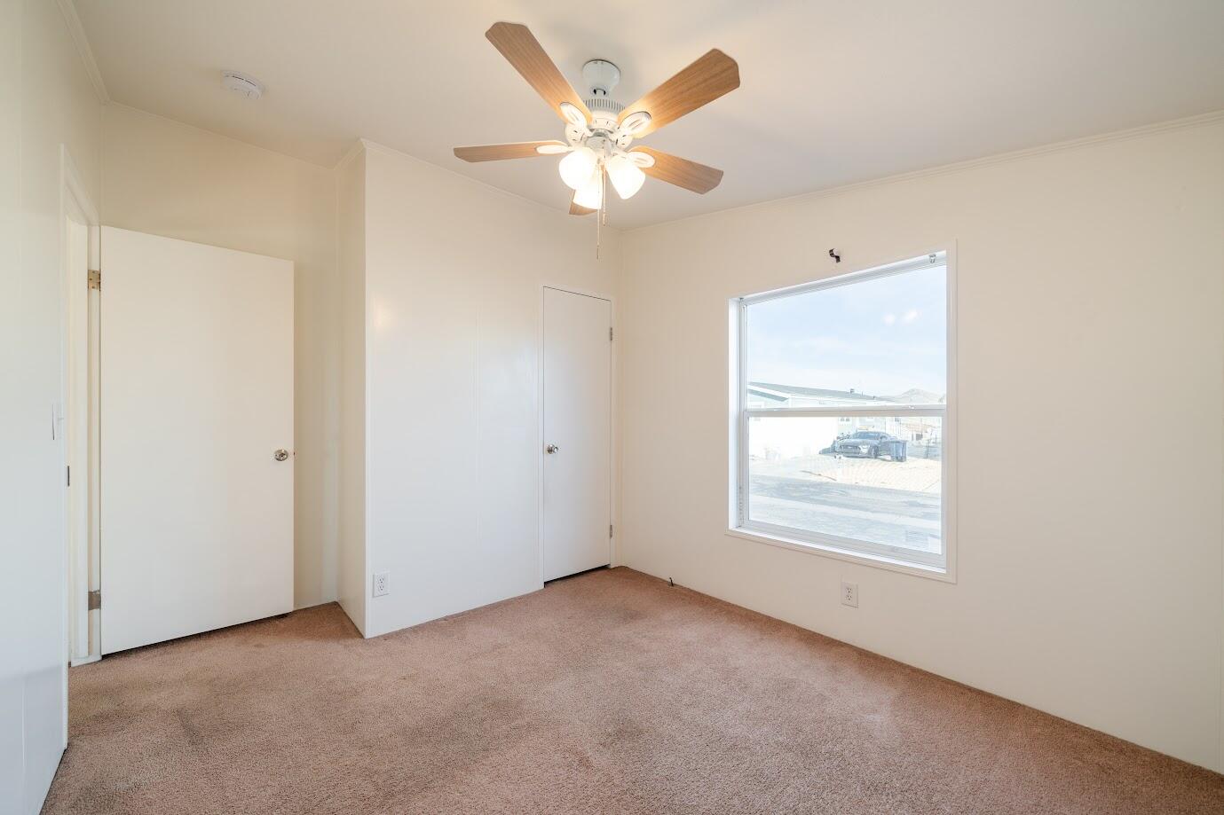 2016 Westerly Drive Rosamond, CA 93560 - Photo 12 of 20 an empty room with a ceiling fan and window