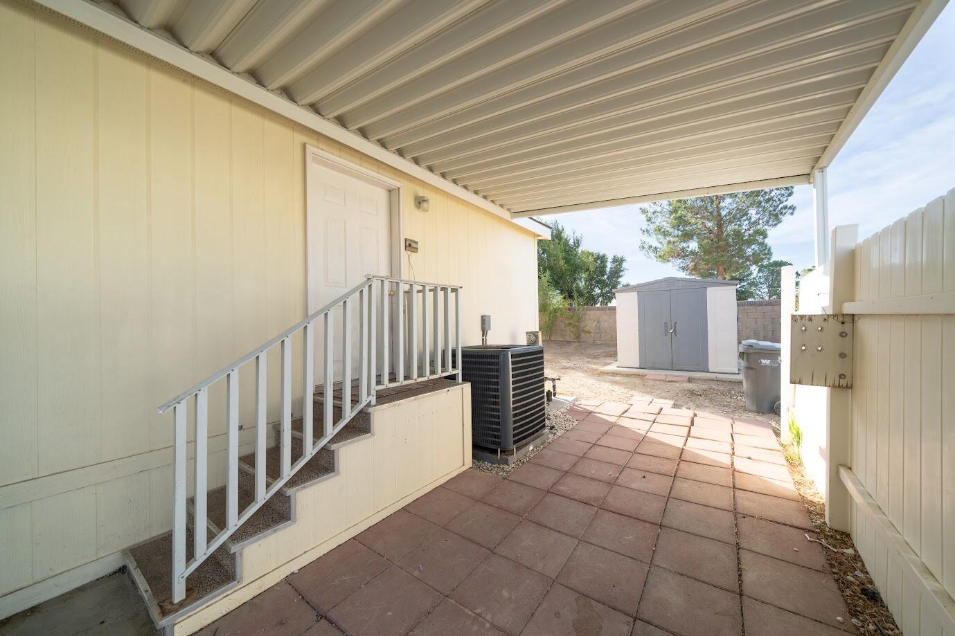 2016 Westerly Drive Rosamond, CA 93560 - Photo 19 of 20 a view of a porch with wooden floor and iron stairs