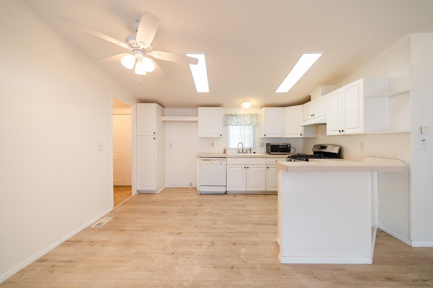 2016 Westerly Drive Rosamond, CA 93560 - Photo 6 of 20 a kitchen with cabinets stainless steel appliances and a window