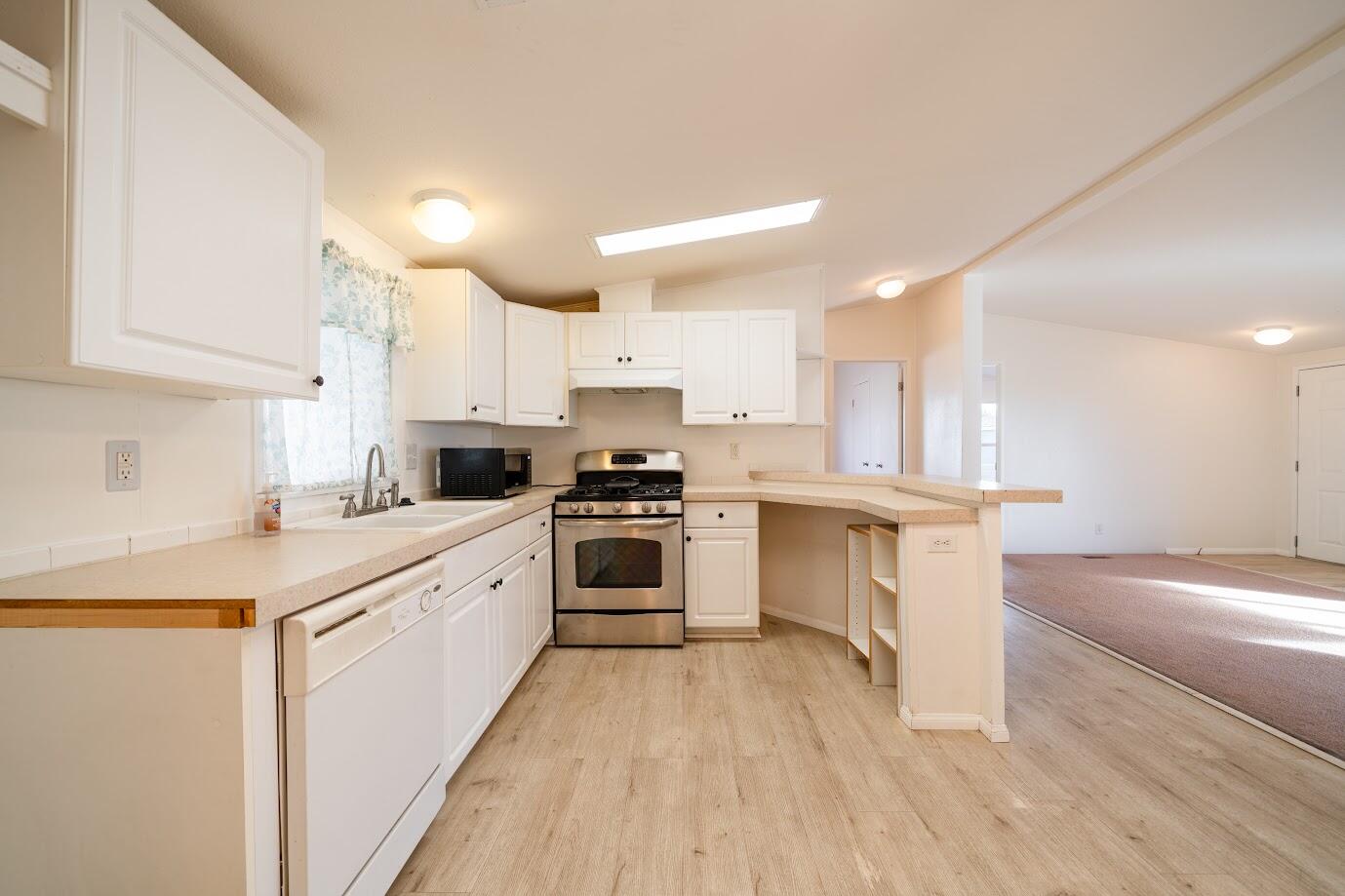 2016 Westerly Drive Rosamond, CA 93560 - Photo 7 of 20 a kitchen with a white cabinets and wooden floor
