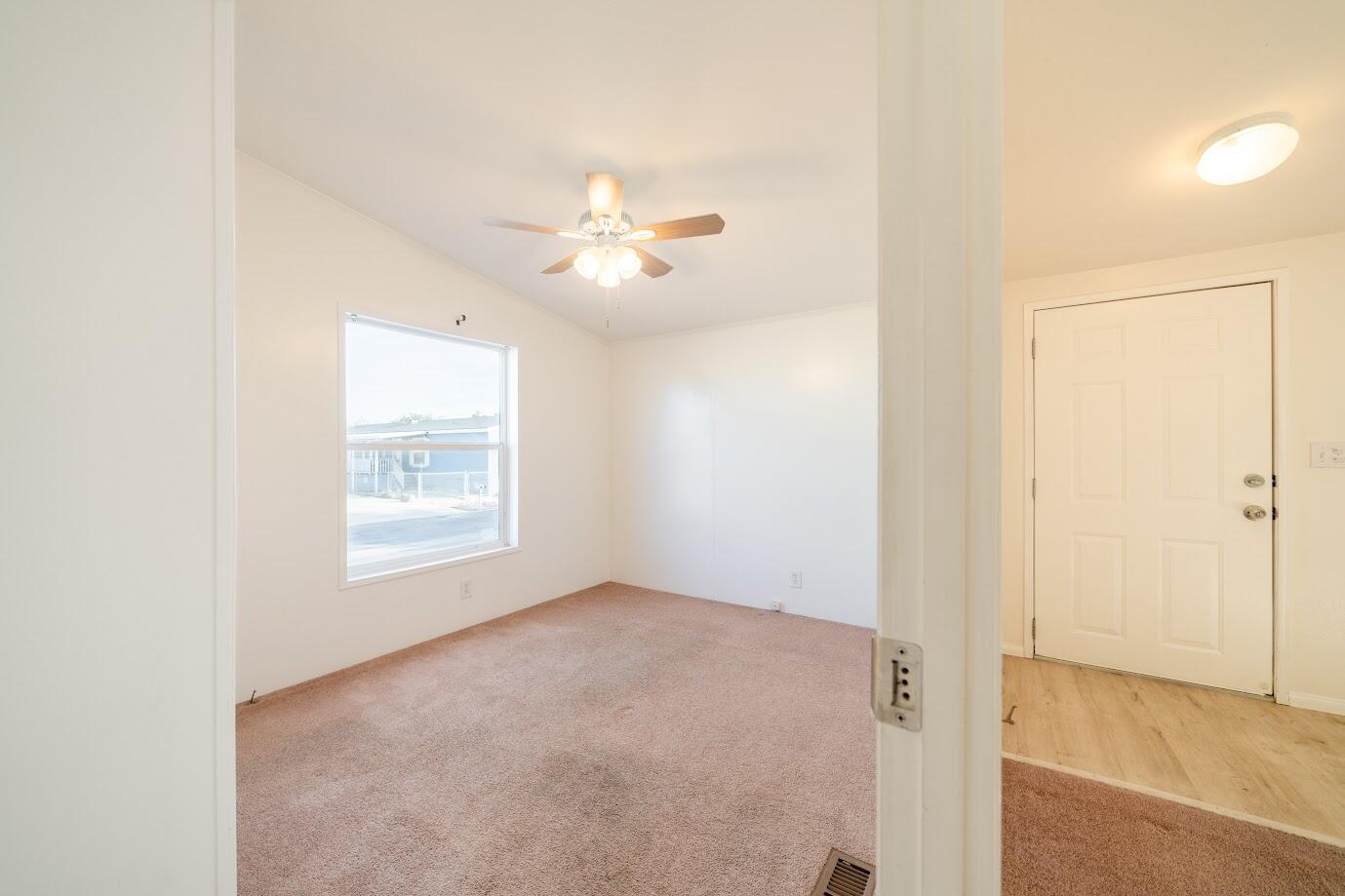 2016 Westerly Drive Rosamond, CA 93560 - Photo 10 of 20 an empty room with windows and ceiling fan